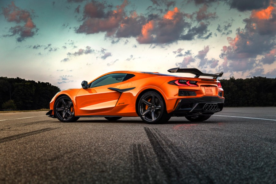 Orange 2023 Corvette on a road at sunset.