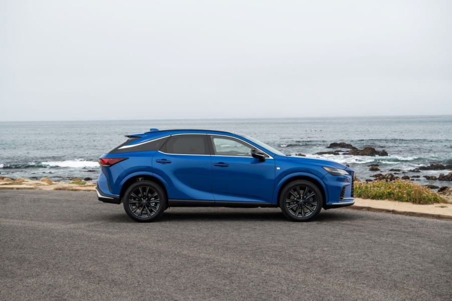 A side profile shot of a 2023 Lexus RX 350 F SPORT compact luxury SUV model with the Grecian Water color option