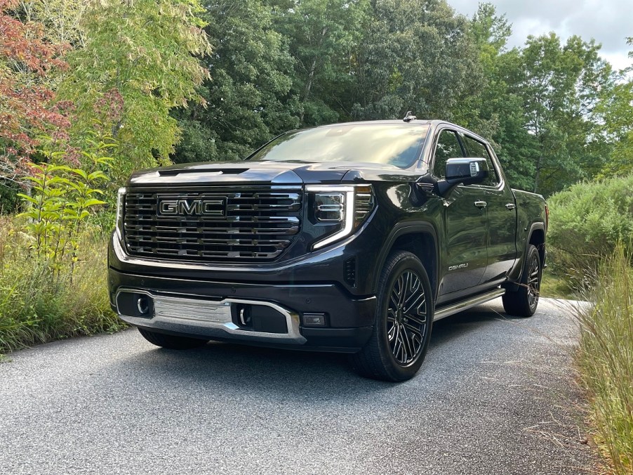 The GMC Sierra 1500 Denali Ultimate parked near foliage