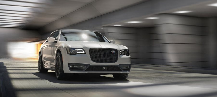 A white 2023 Chrysler 300C barrels through a tunnel.