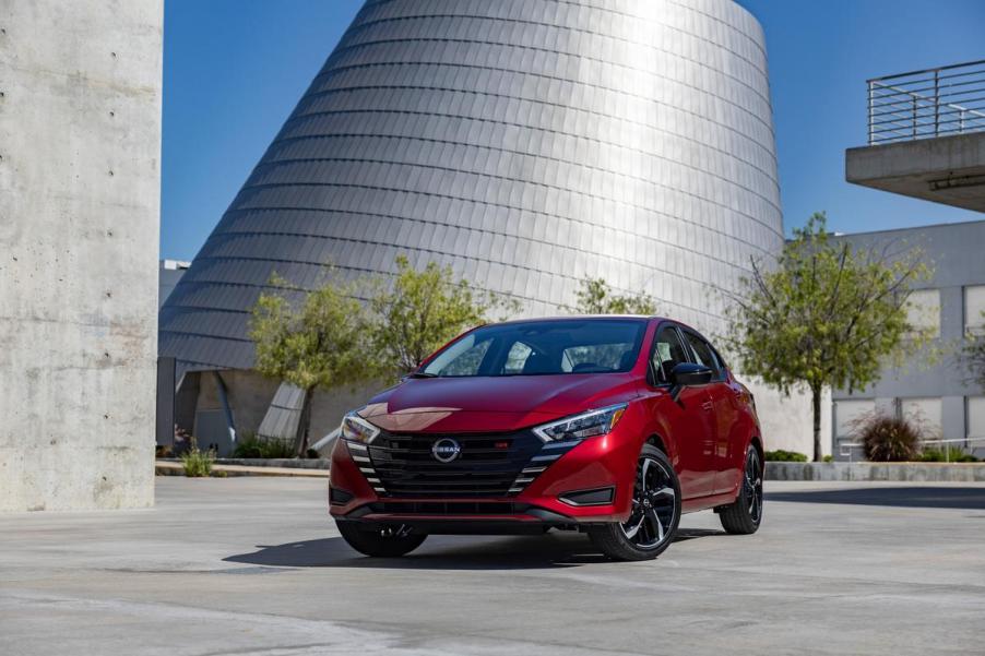 A red 2023 Nissan Versa on display outside.