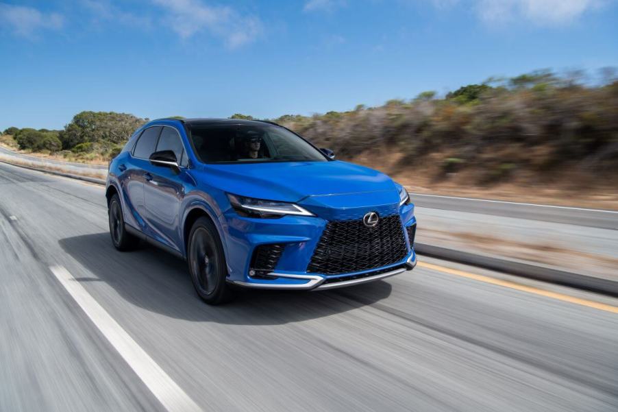 A 2023 Lexus RX 350 midsize luxury SUV model traversing down a country highway.