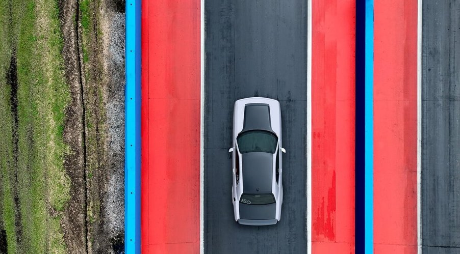 A silver and black Dodge Challenger SRT Demon 170 sits on a drag strip.