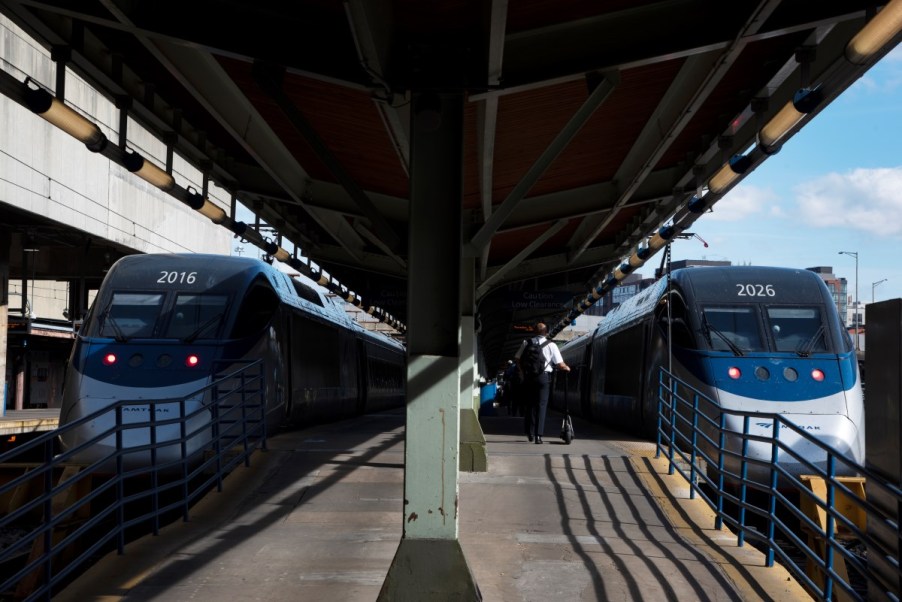 A pair of Acela trains parked side-by-side at a public transit station