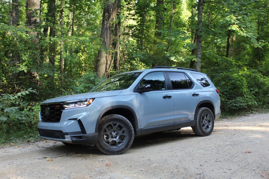 The 2023 Honda Pilot TrailSport off-roading in the woods