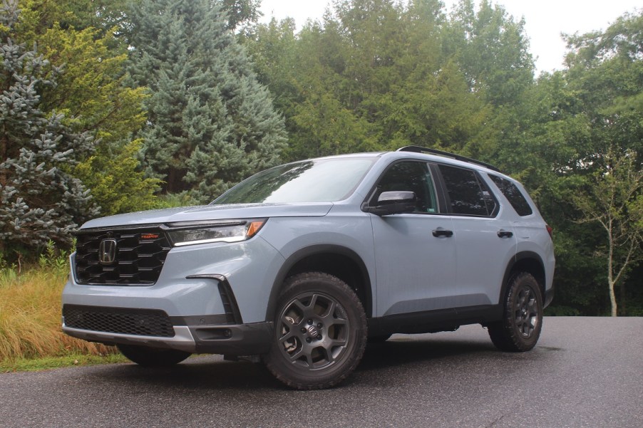 The 2023 Honda Pilot parked near foliage