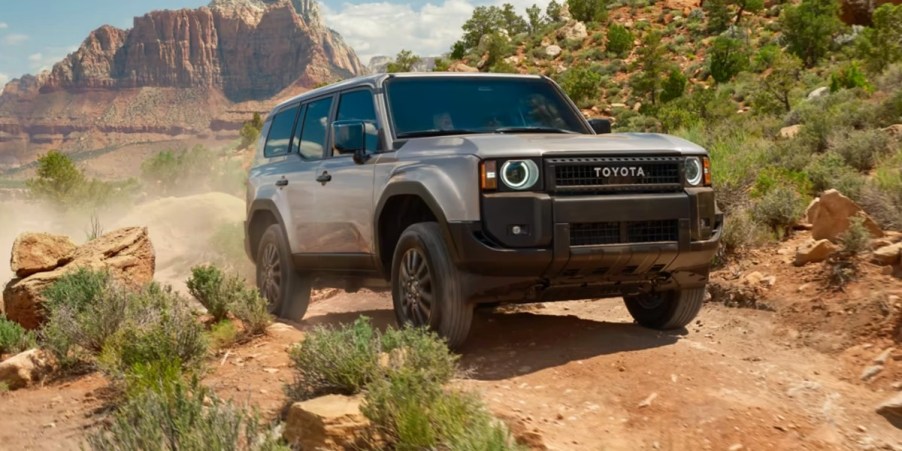 A gray 2024 Toyota Land Cruiser is driving off-road.