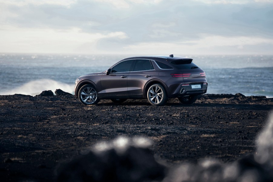 A gray 2023 Genesis GV70 parked in front of a cliff. There are plenty of Genesis GV70 trims to pick from.