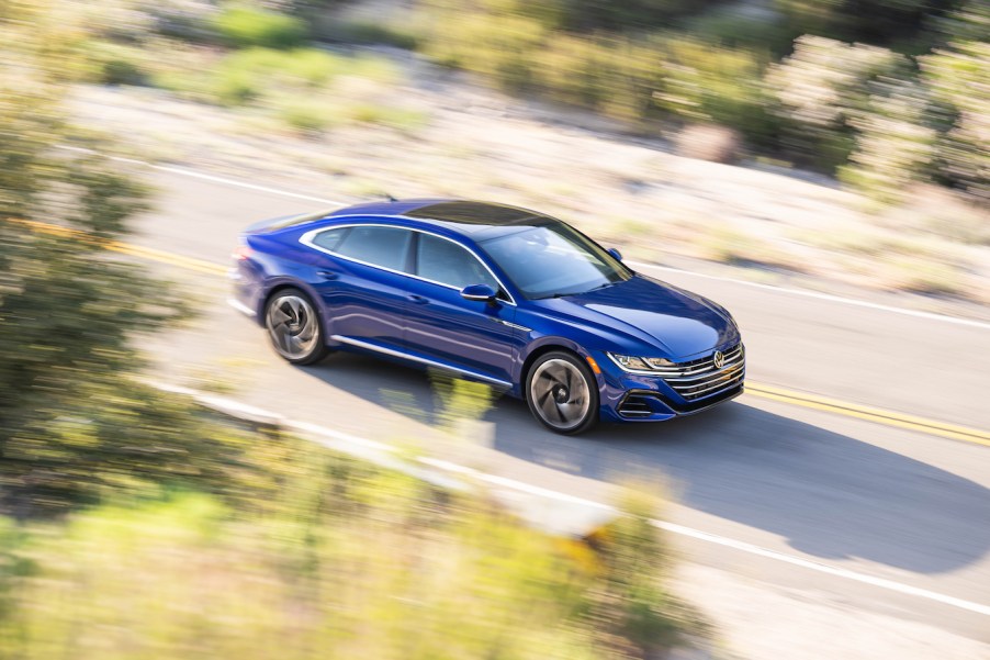 An overhead shot of a speeding blue Volkswagen Arteon. The last Volkswagen Arteon is going on sale for the 2024 model year.