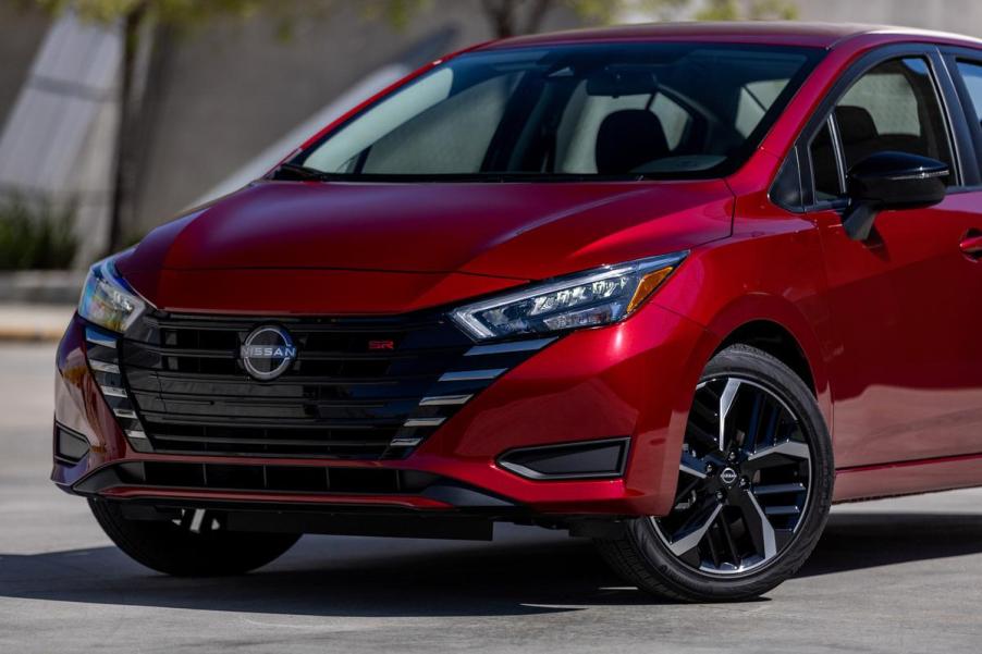 A red 2023 Nissan Versa on display.