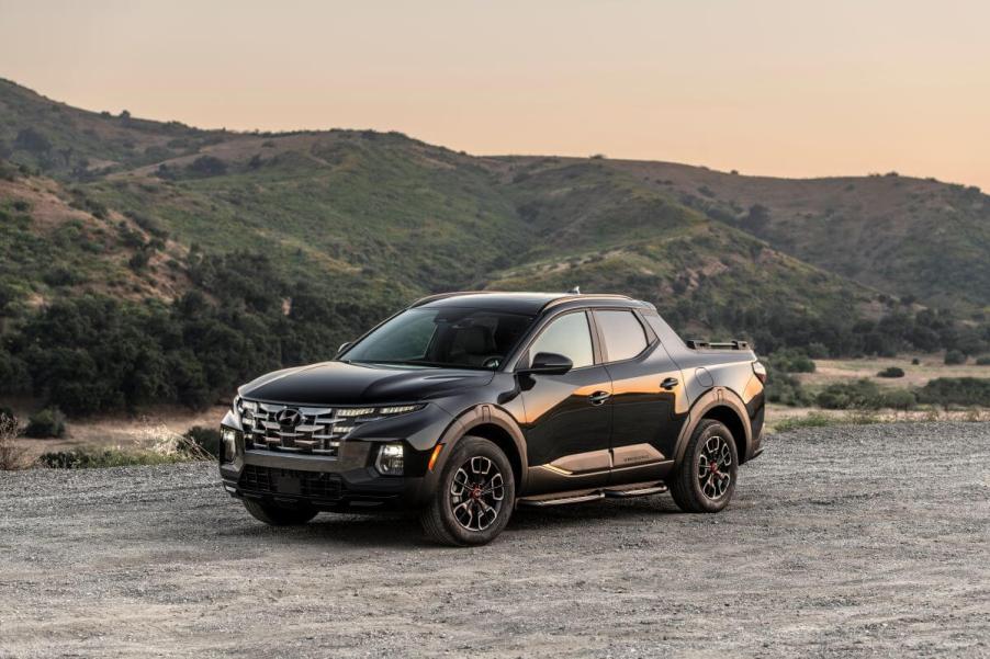 A 2024 Hyundai Santa Cruz XRT compact pickup truck model parked on a dirt gravel plain