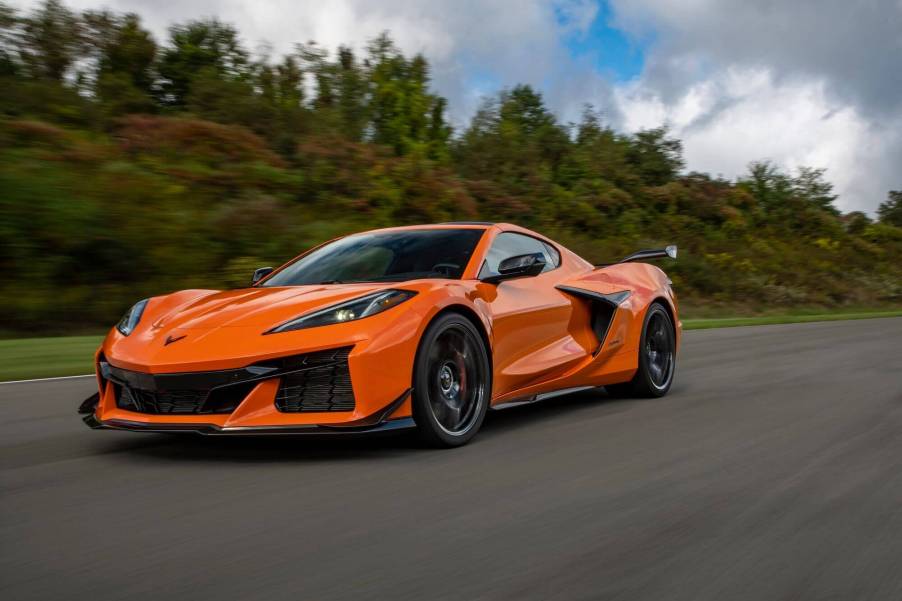 A bright-orange 2023 Chevrolet Corvette Z06 cruises down a track.