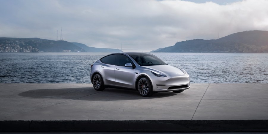 A gray 2023 Tesla Model Y small electric SUV is parked.