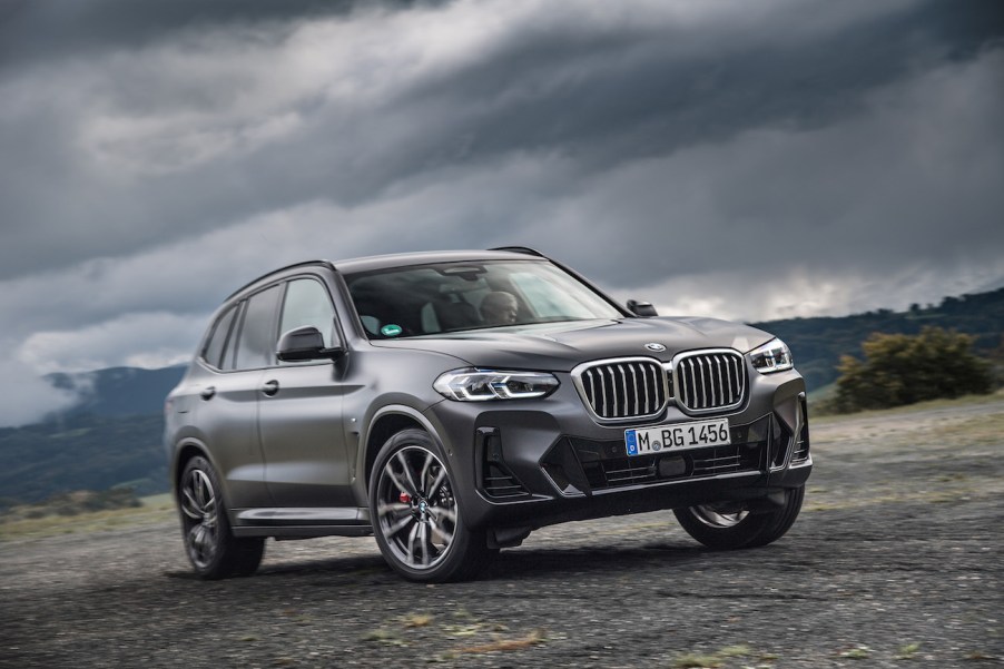 A black 2023 BMW X3 parked on a stormy day. The X3 is one of a few affordable luxury compact SUV options.