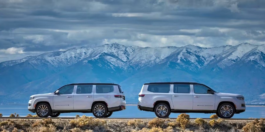 White Jeep Wagoneer and Grand Wagoneer full-size SUVs are parked.