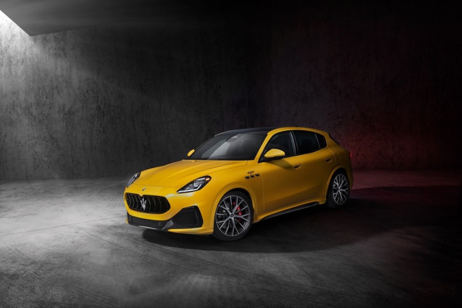 A yellow Maserati Grecale Trofeo on display against a gray backdrop. The Maserati Grecale's price is a huge barrier to entry.