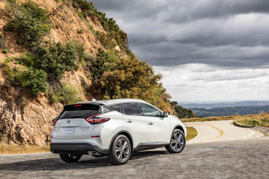 Nissan's most reliable SUV, the 2023 Nissan Murano, pictured in white parked ahead of a cliff.