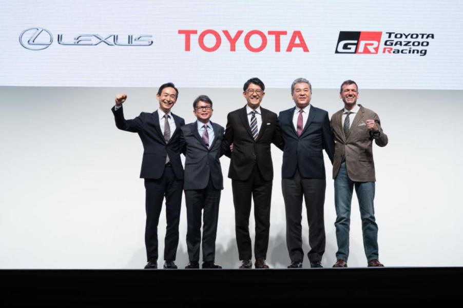 Toyota's CEO and other board members pose for a photo at an event.