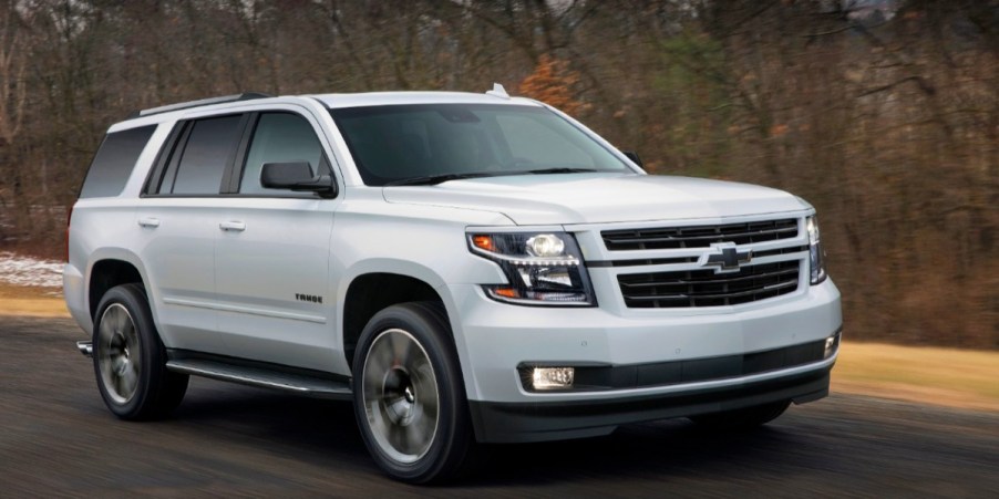 A 2018 Chevrolet Tahoe full-size SUV is driving on the road.