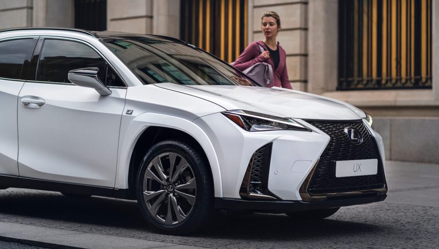 A white 2023 Lexus UX 250h parked on the street. The 2023 Lexus UX resale value is pretty high.