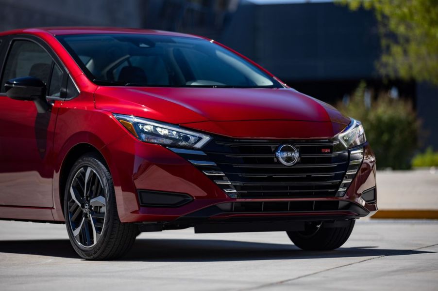 A red 2023 Nissan Versa on display.