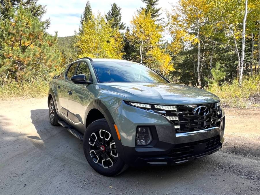 A front corner view of the 2024 Hyundai Santa Cruz XRT on a dirt road