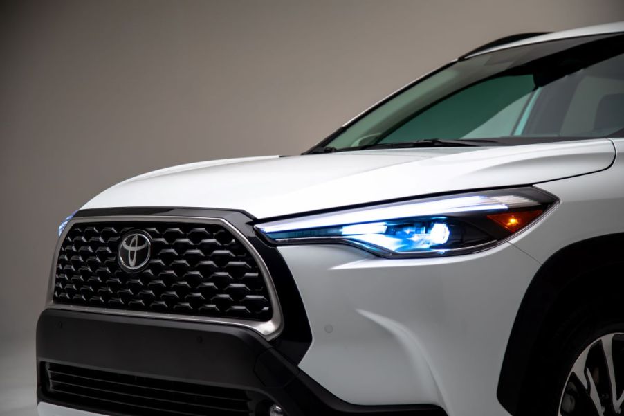 An exterior shot of the grille and headlights on a 2024 Toyota Corolla Cross subcompact SUV in Wind Chill Pearl