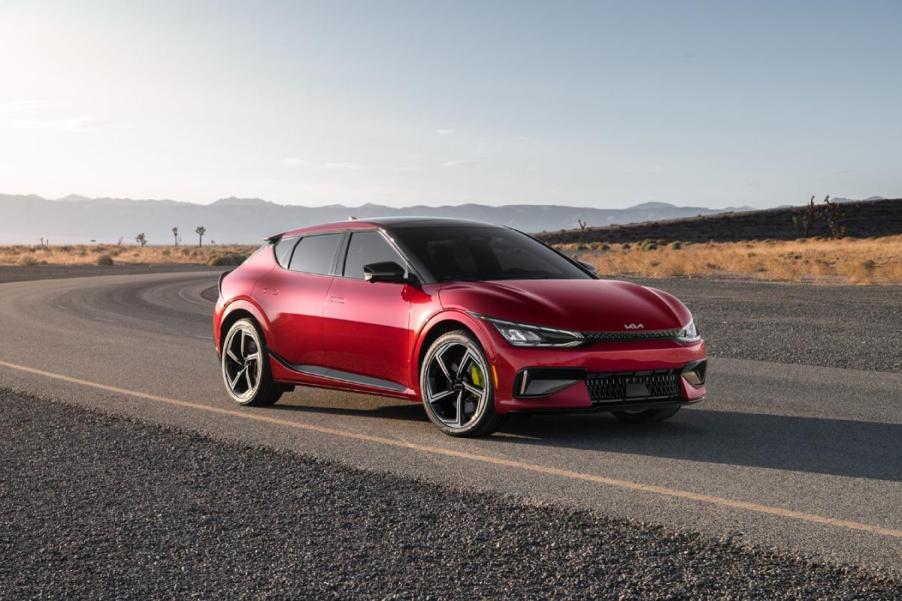 A red 2024 Kia EV6 GT driving down the road.