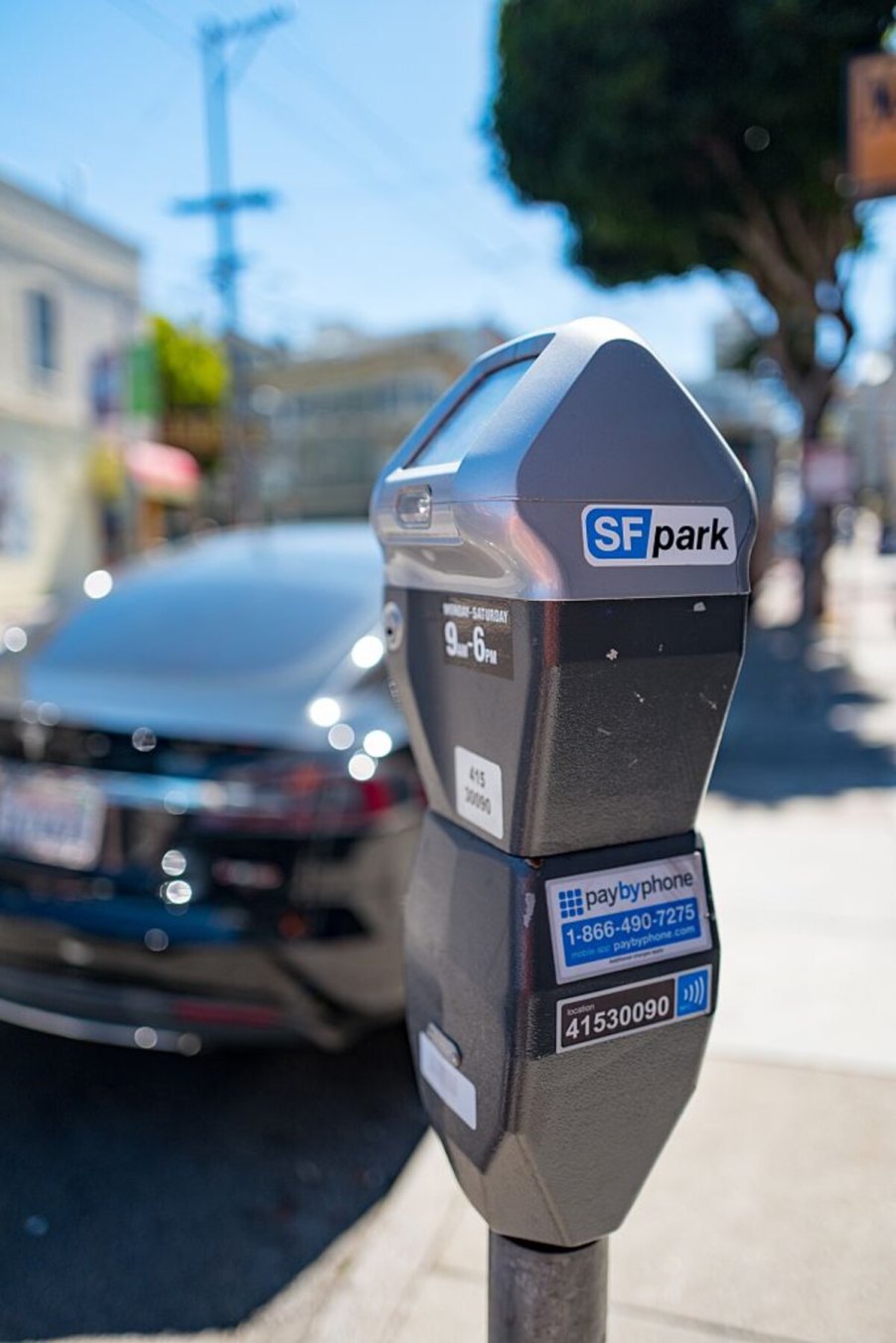 A lone San Francisco parking meter with car in background