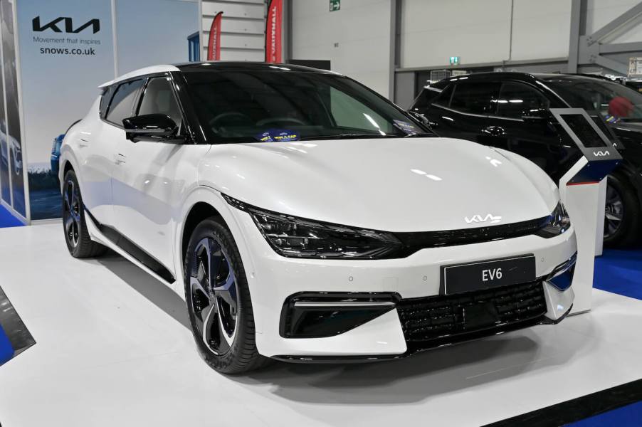 A white Kia EV6 at the British Motor Show at Farnborough International Exhibition Centre. Kia EV6 sales are rising.