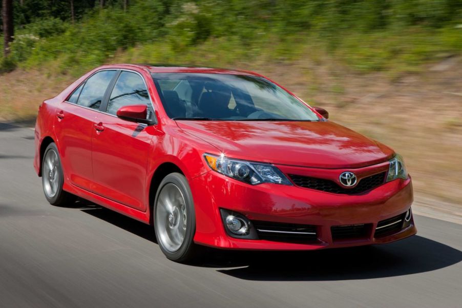 A red 2014 Toyota Camry on display.