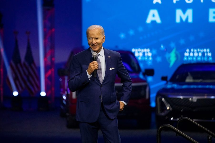 Joe Biden speaks at a the North American International Auto Show amid Chevrolet Corvettes and new cars.