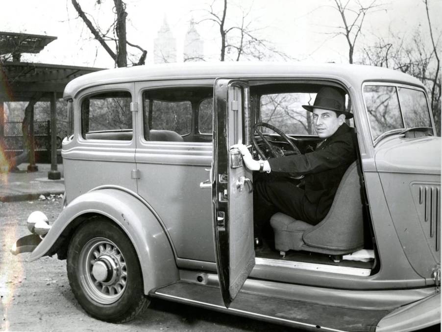 Race car driver piloting 1933 DeSoto backward