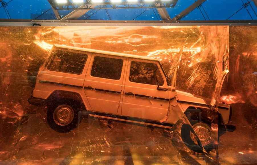 A white 1979 Mercedes-Benz G-Class 280 GE sealed in a resin cube at the Detroit Auto Show in 2018