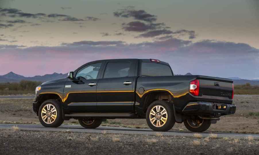 A black 2016 Toyota Tundra parked in left profile view outside at dusk