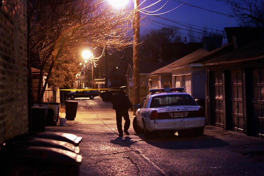 A police officer at a crime scene at night