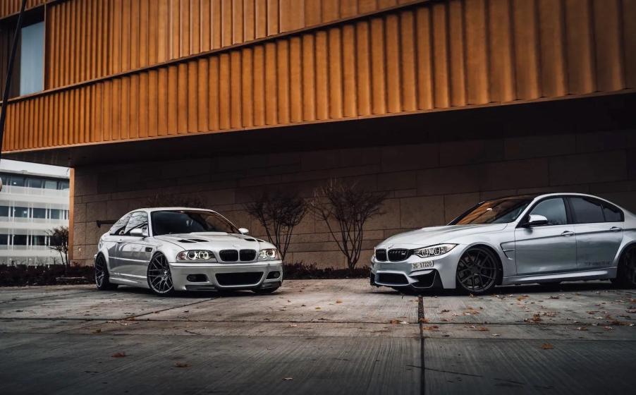 E46 generation BMW M3 parked next to a new 3 Series in front of a brick and metal building