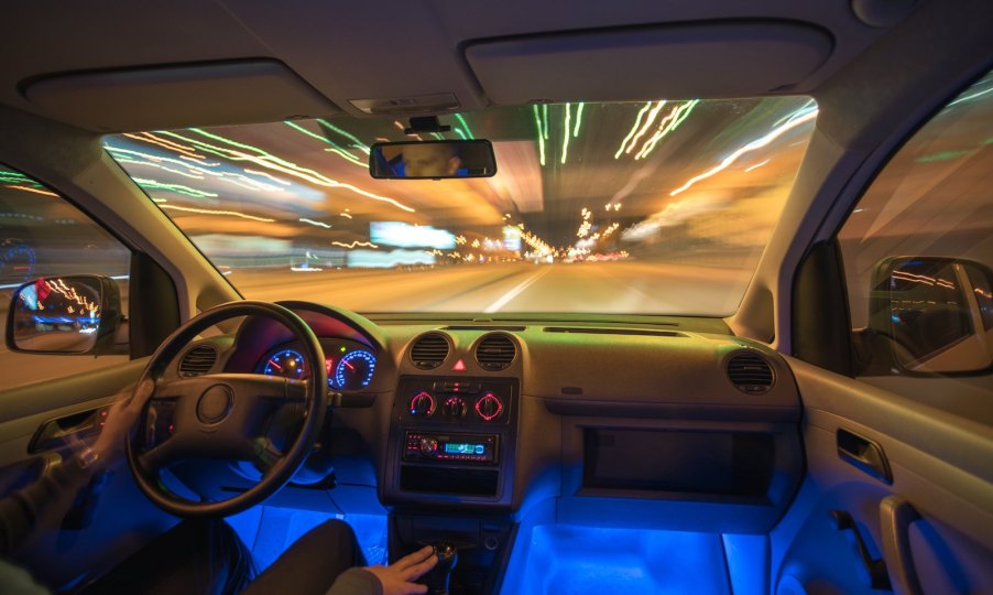 Sedan with a glowing blue light beneath its dashboard