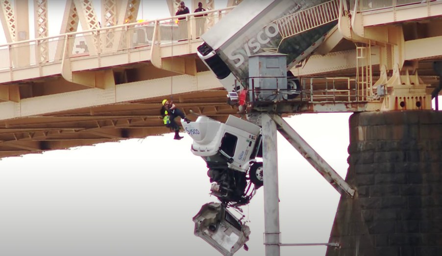 Firefighter hangs off Kentucky bridge to rescue semi truck driver