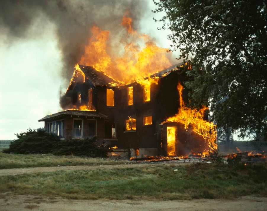 Yellow and orange flames demolish a suburban home.