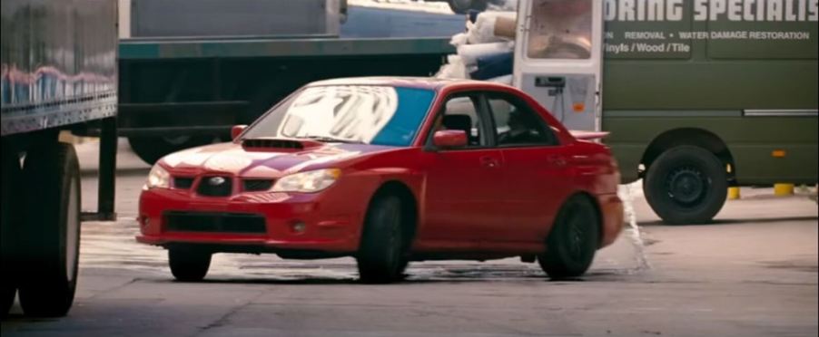 A red 2006 Subaru Impreza WRX slides in Baby Driver.