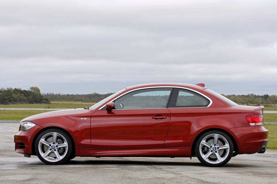 An E82 BMW 1 Series, like the 128i or 135i, shows off its side profile.