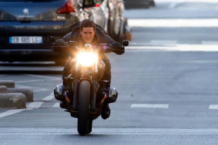 Tom Cruise rides a BMW R nineT Scrambler motorcycle on the movie set for "Mission Impossible: Fallout."