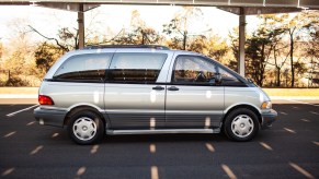 A silver 1994 Toyota Previa is parked in full right profile view