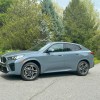 The 2024 BMW X2 parked near foliage