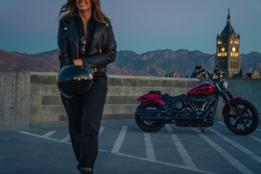 A rider walks away from a 2024 Harley-Davidson Street Bob 114 cruiser motorcycle.