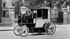 A man driving an electric car in 1897