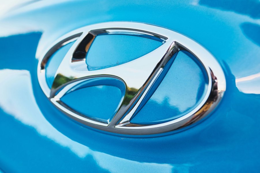 The chrome "H" logo on a blue Hyundai's hood.