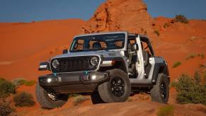 A silver Jeep Wrangler 4xe Willys has an estimated 22 miles of range in EV mode.