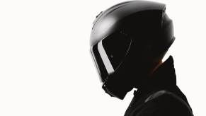 A rider shows off the full-face type of motorcycle helmet from the side profile.